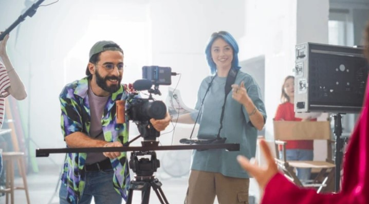 Young Caucasian Male And Female Filmmakers Collaborate On A Film Set